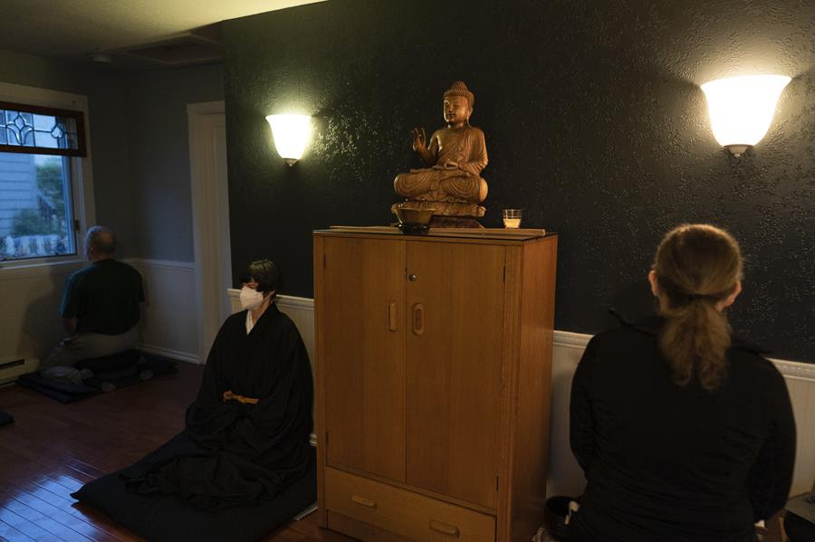 Resident priest Genmyo Jana Zeedyk, second from left, and other members of the Anchorage Zen Community meditate during a Sunday service in Anchorage, Alaska.