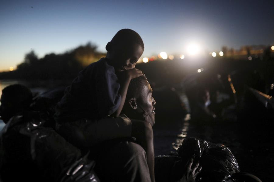 In this Thursday, Sept. 23, 2021 file photo, migrants, most from Haiti, cross the Rio Grande towards Del Rio, Texas, from Ciudad Acuña, Mexico.