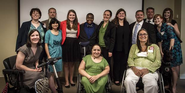 Group of interns, USICD staff and board, and funders post for group picture