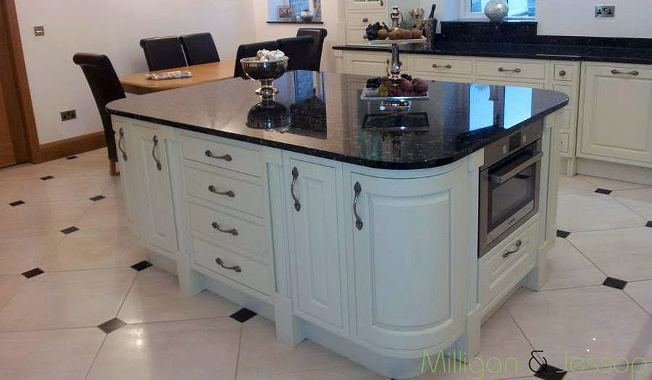 Stainless steel appliances, recess lights, stainless steel hood, and sink an outstanding example of uba tuba granite with shaker cherry golden honey color cabinets. Cat Eyed Lady Emerald Pearl Granite Countertop