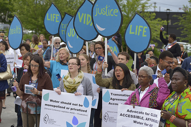 Participants in a vigil for environmental justice at the 2016 United Methodist General Conference in Portland, Ore., hold signs highlighting the struggle for clean water around the world. The Vigil was sponsored by United Methodist Women. Photo by Paul Jeffrey, UM News.