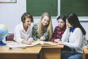 photo of four children working in a group