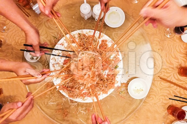 This is why yee sang is a popular dish among malaysians and singaporeans during chinese new year as a symbol of abundance, prosperity and vigor. Motion Hands With Chopsticks Tossing Yee Sang Meal In Stock Photo Image 128746 Symzio