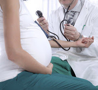 Pregnant woman with doctor