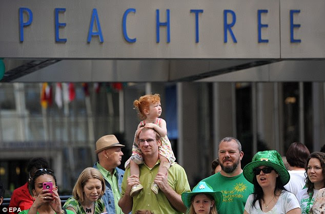 Lining up: Down south in Georgia, spectators eagerly waited a glimpse of Atlanta's 130th St. Patrick's Day Parade