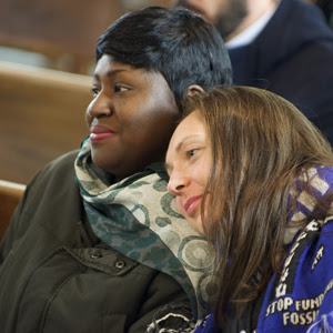 Photo of two smiling women sitting in a church pew.