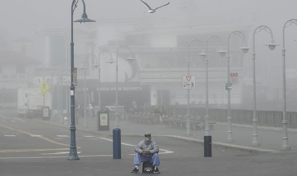 A street performer sits alone at Fisherman&#39;s Wharf in San Francisco, Thursday, March 12, 2020.  California Gov. Gavin Newsom said Thursday that sweeping guidance for Californians to avoid unnecessary gatherings to avoid the spread of the new coronavirus will likely extend beyond March. The statewide guidance applies to sporting events, concerts and even smaller social gatherings in places where people can&#39;t remain at least 6 feet (2 meters) apart. For most people, the new coronavirus causes only mild or moderate symptoms. For some it can cause more severe illness. (AP Photo/Jeff Chiu)