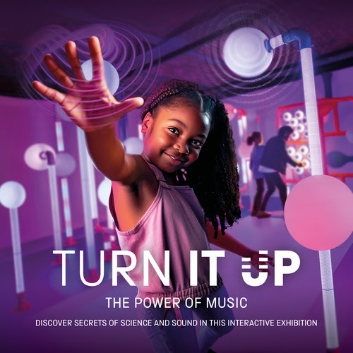 A child posed with arm outstretched and hand open facing towards the camera against a purple background. Text says Turn It Up The Power of Music.