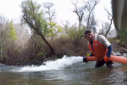 A U.S. Fish and Wildlife employee reintroduces salmon into a Central Valley river.