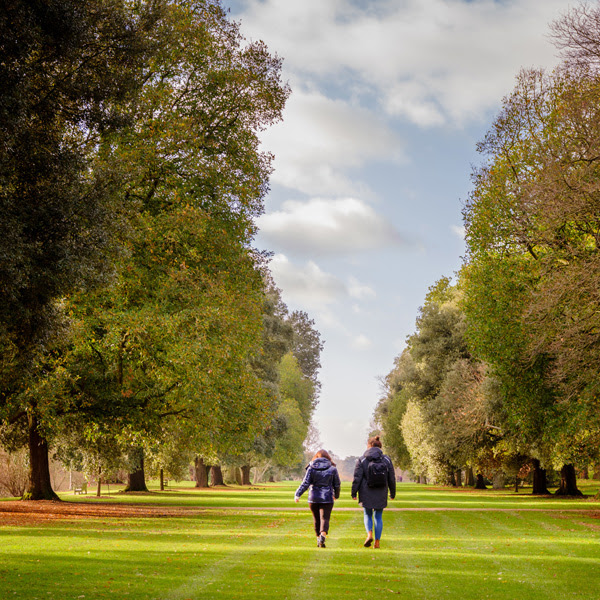 Two visitors walking on Syon Vista