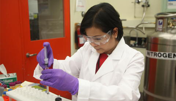 NIST chemist Connie Remoroza in her lab, working to prepare a milk sample