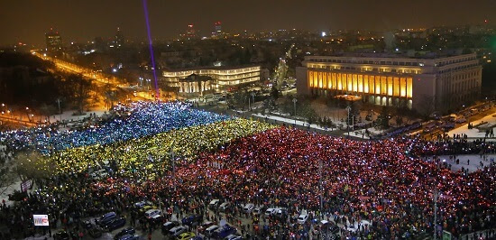 A general view of the Victoriei Plaza full of protesters flashing the lights on their cell-phones under coloured pieces of paper, all at the same time to form a huge national flag, during a protest in front of the government headquarters in Bucharest, Romania, 12 February 2017.