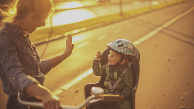 A mom and son on a bicyle