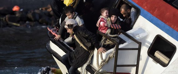 Refugees and migrants try to leave their boat as it sinks off the Greek island of Lesbos island while crossing the Aegean sea from Turkey on October 30, 2015. AFP PHOTO / ARIS MESSINIS