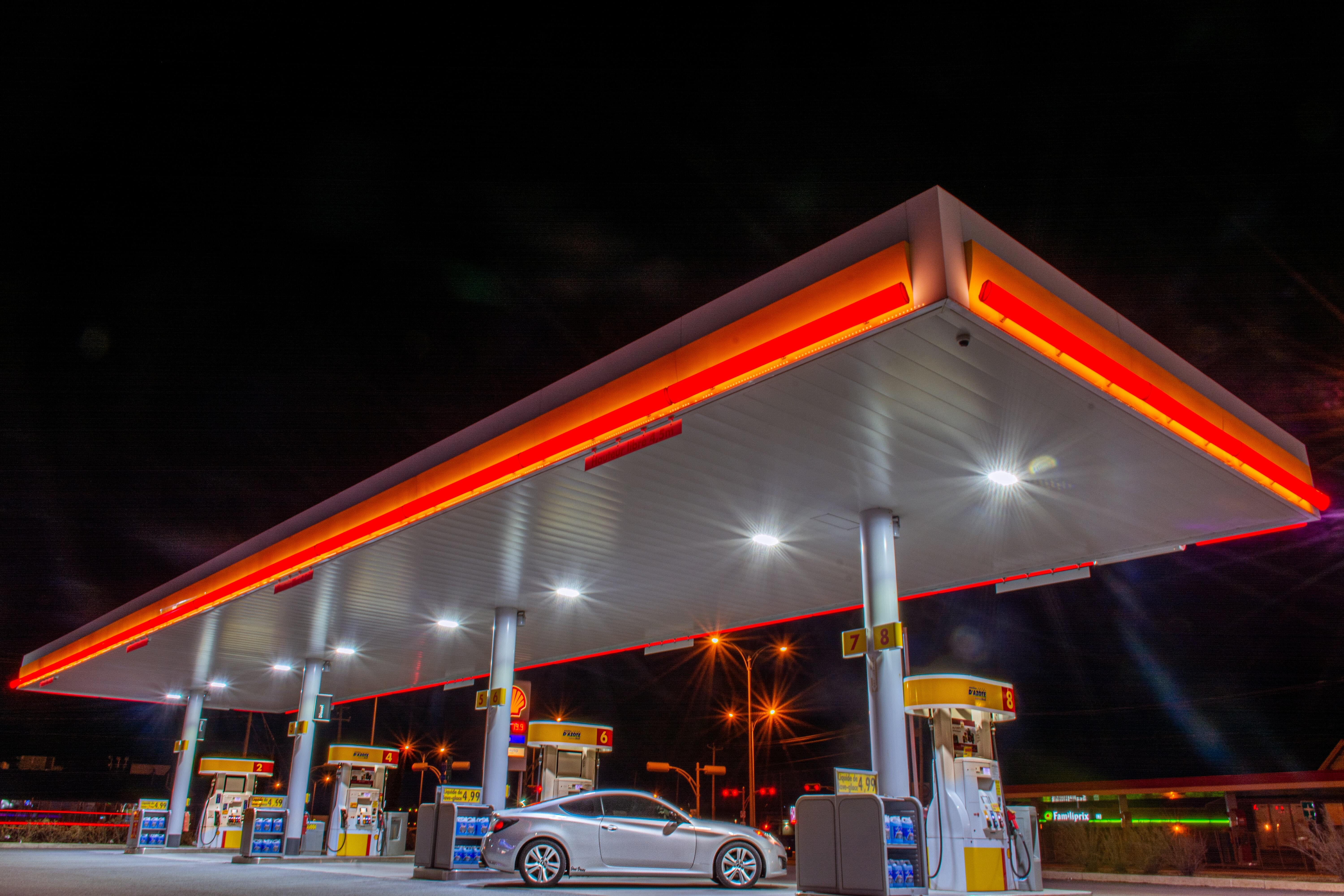 Photo of a gas station at night time.