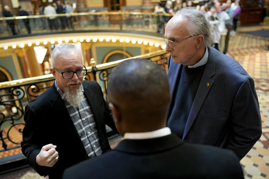 Rev. Mike Demastus, of Des Moines, Iowa, left, and Rev. Bob Curry, of Johnston, Iowa, right, talk with State Rep. Eddie Andrews, center, Thursday, April 6, 2023, at the Statehouse in Des Moines, Iowa.