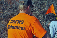FWS volunteer wearing a shirt that says "FWS Volunteer" 