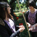 Micaela Bazo, left, and Stephanie Lin, graduate students, marking stakes for oak saplings in Oakland, Calif.