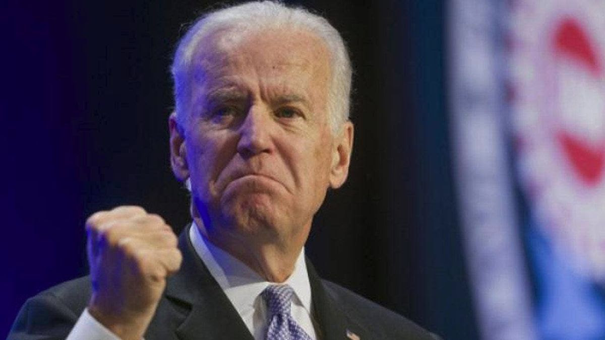 Photo of Joe Biden with e mean look shaking his fist.