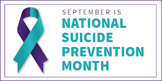 A purple and teal suicide-prevention ribbon, with the words Suicide Prevention. 