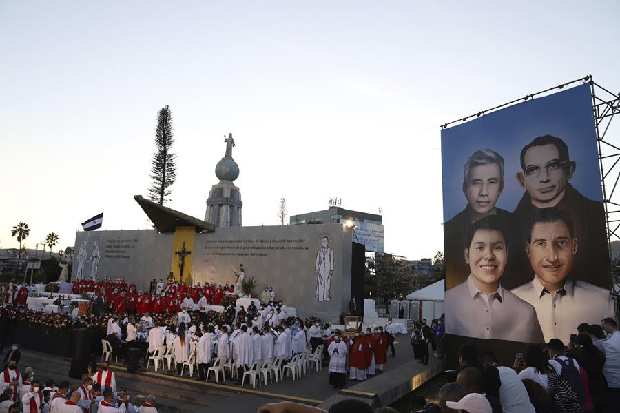 A poster depicting the Rev. Rutilio Grande, Franciscan priest Cosme Spessotto, Nelson Lemus and Manuel Solorzano, all victims of right-wing death squads during El Salvador’s civil war, is displayed during their beatification ceremony in San Salvador.