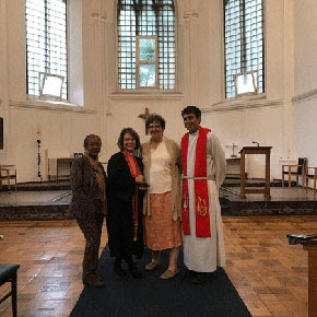 Rev. Jessica Derise standing with three women