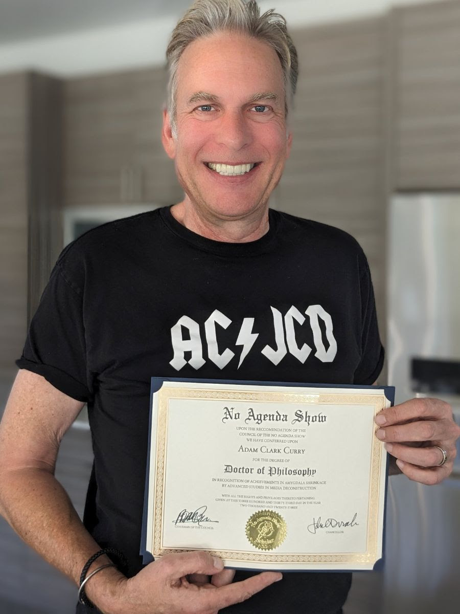 Photo of Adam Curry holding PhD.