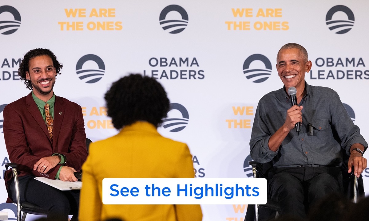 President Obama is seated next to a man with dark-medium skin tone and curly hair. Both are smiling in front of a backdrop that says "Obama Leaders" and are smiling at a person standing up facing away from the camera. On the bottom, a button says "See the Highlights".