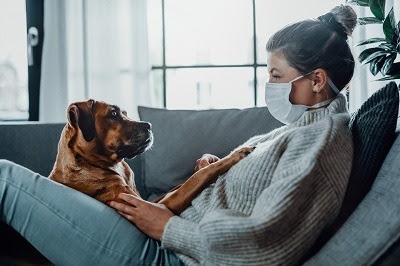 woman wearing mask with dog