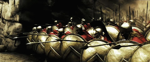 The
Spartans align themselves in a tight formation of shields and spears pointed forward.