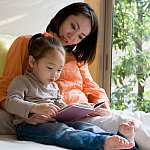 Mother and daughter reading a picture book.