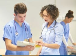 photo of two health professionals looking at a patient's chart