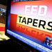 Wall Street investors watched as the Federal Reserve announced on Dec. 18 that it would begin tapering its bond-buying program.
