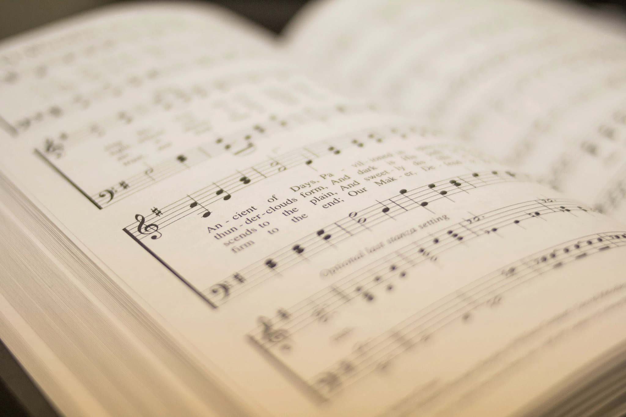 Close up photo of an open hymn book.