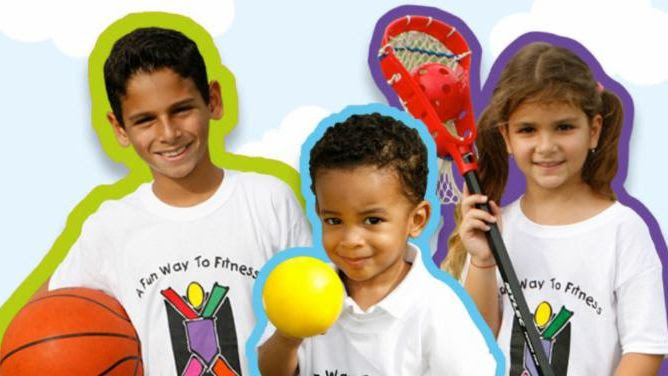 Children from the Kidokinetics sports classes pose with sports equipment.