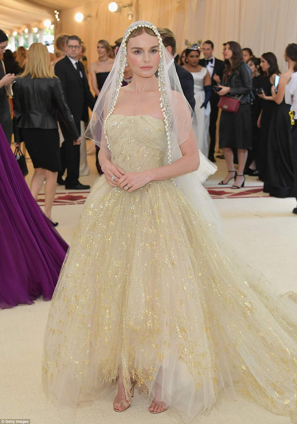 Beleza velada: Kate Bosworth vestiu um vestido dourado e creme com uma grande saia rendada, acrescentando um vÃ©u de pÃ©rola;  ela estÃ¡ vestindo Oscar de la Renta