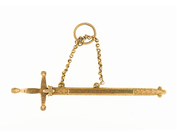 Miniature gold sword