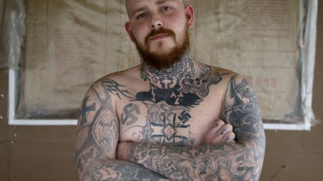 Shane Johnson displays some of his tattoos as he poses in his home in Tippecanoe, Indiana, Thursday, Jan. 12, 2017. (AP Photo/Michael Conroy)