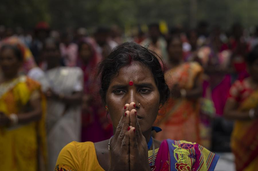 A tribes woman prays during a sit-in demonstration rally to demand of recognizing Sarna Dharma as a religion in Ranchi, capital of the eastern Indian state of Jharkhand, Oct. 18, 2022.