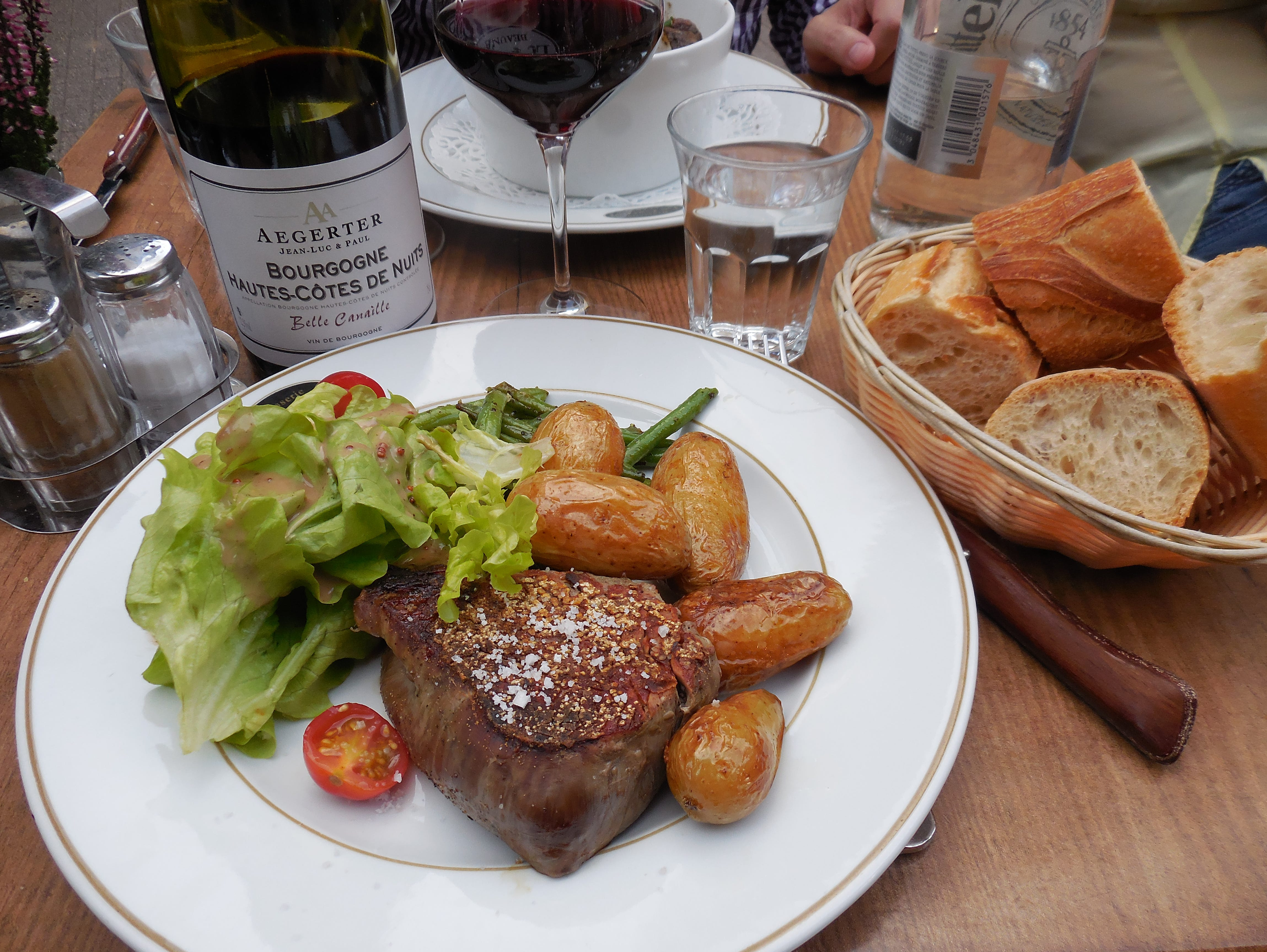 A classic French meal at Brasserie le Carnot in Beaune: steak with roasted potatoes and salad in a mustardy vinaigrette with red wine.