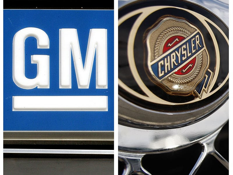 In this combo made with file photos, logos for General Motors and Chrysler are shown. Automakers should not expect a quick turnaround in consumer demand, auto industry analysts said Tuesday, Jan. 13, 2009, predicting the struggling economy could lead