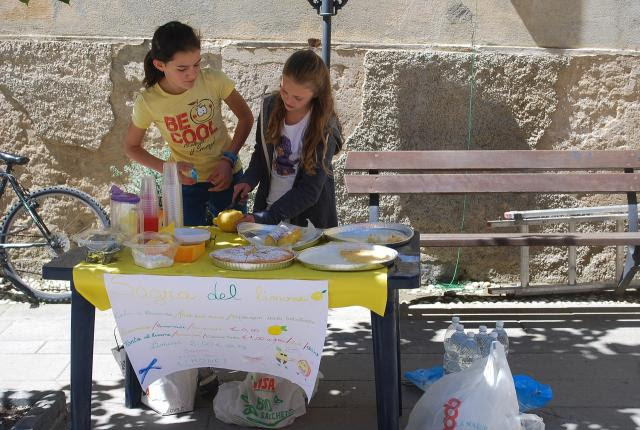 Youth making selling lemonade at a lemonade stand