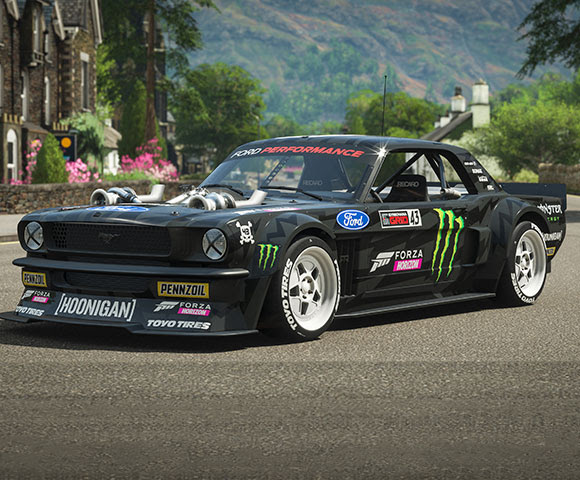 A black, custom-built racing vehicle sits parked on a road.