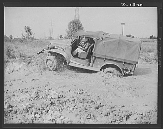 Army truck manufacture (Dodge). Army officers attending the school conducted by the Chrysler Corporation to assist our fighting forces in the job training men to operate the thousands of trucks required by today's streamlined division are given actual practice in driving the trucks in a testing field. Above is an Army officer putting one of these trucks through its paces in a heavy mud wallow which is just one of the many tests to which the driver and vehicle are subjected