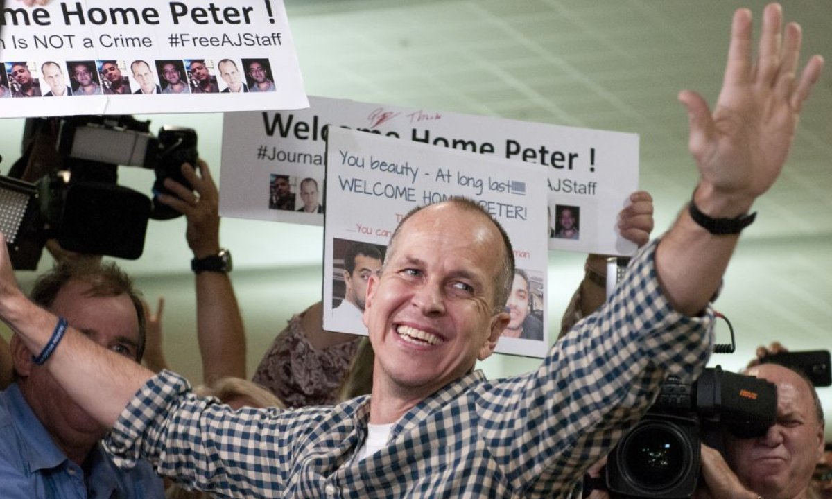  Peter Greste is kissed by his mother Lois and father Juris upon his arrival at Brisbane’s international airport. Photograph: Patrick Hamilton/AFP/Getty Images