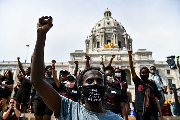 Demonstrators raise their fists outside the State Capitol of Minnesota during a protest over the death of George Floyd.