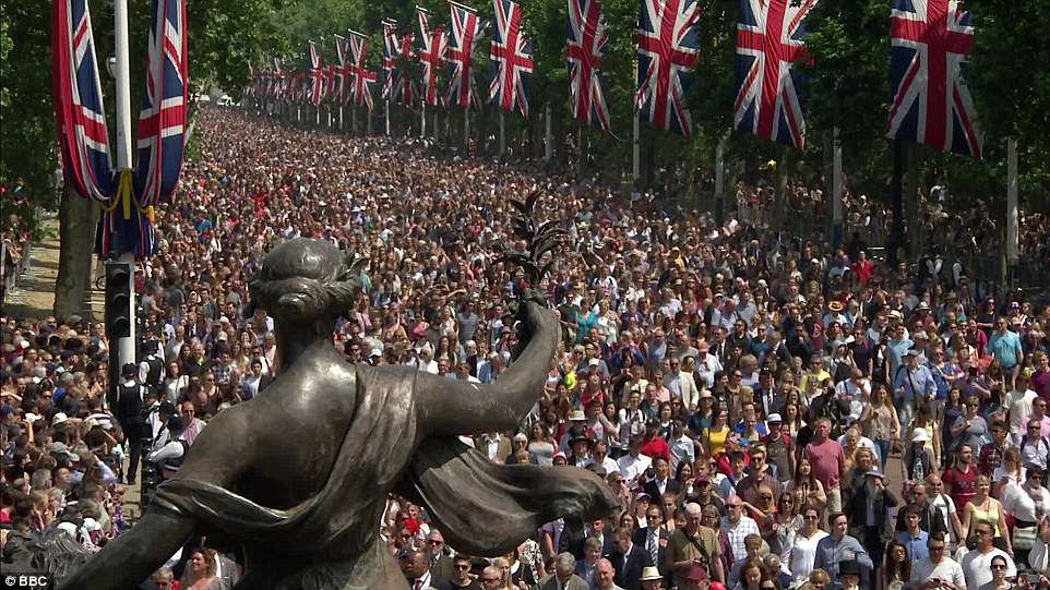 Tens of thousands of cheering Royal enthusiasts flocked to Whitehall to see the royals mingle on the balcony, with Meghan and Kate sharing a chuckle while Harry watched on