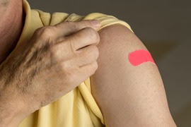 Arm with bandage after vaccine