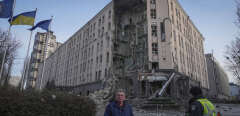 People stand in front of damaged hotel at the scene of Russian shelling in Kyiv, Ukraine, Saturday, Dec. 31, 2022. (AP Photo/Efrem Lukatsky)/XSG105/22365476681808-0//2212311425