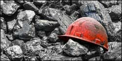 The figure above is a photograph showing a miner’s helmet among coal.